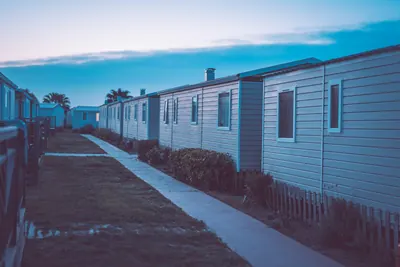 Row of mobile homes along a walkway at dusk